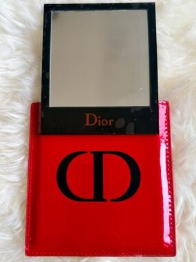 Red Dior Case w Black ‘CD’ Mirror. Mirror is Black w Red ‘Dior’. Remains SEALED